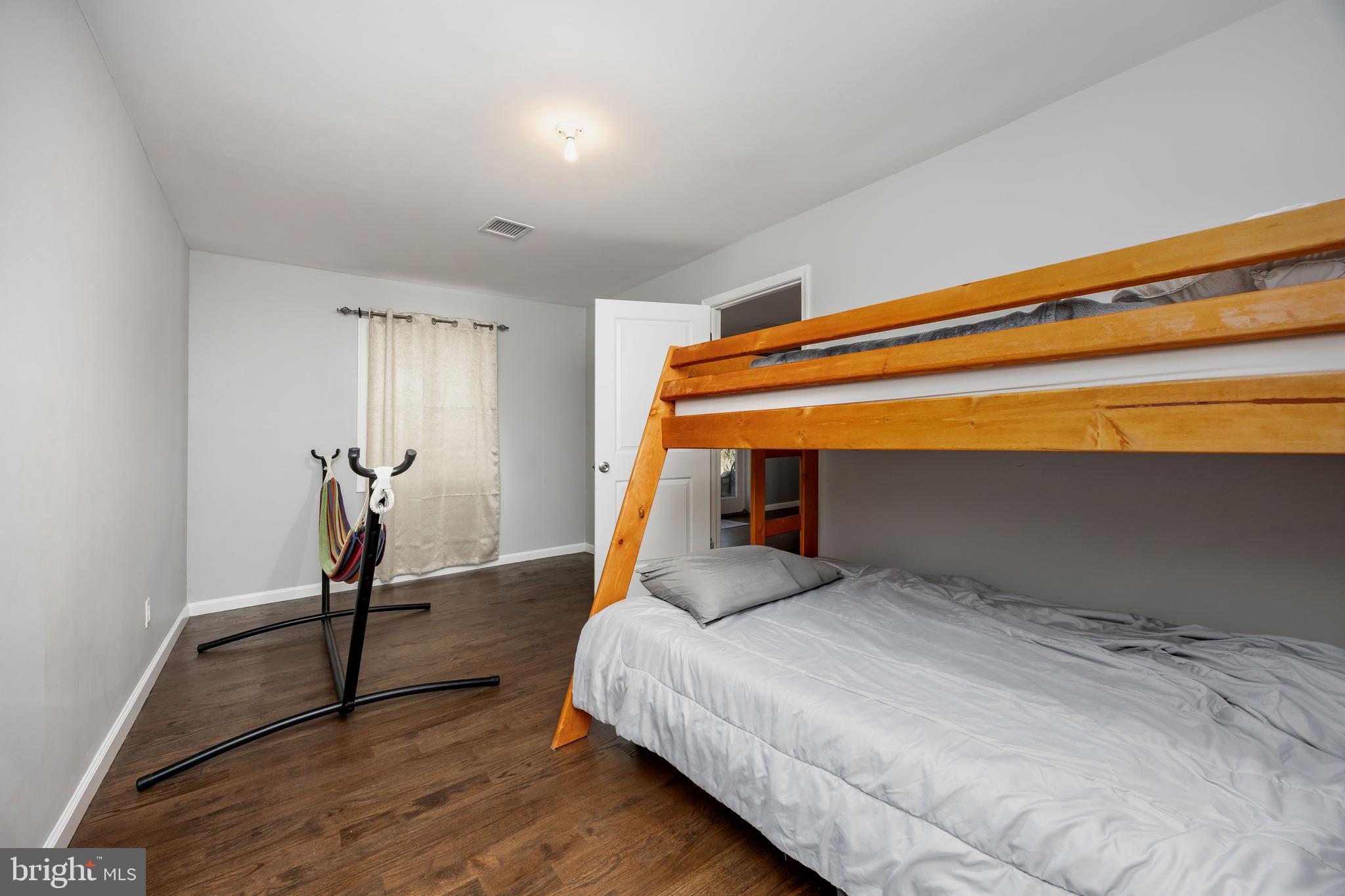 14470 Backbone Road Eden, MD 21822 - Photo 35 of 55 a bedroom with a bed and a chandelier