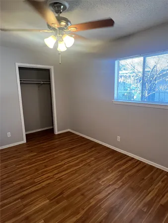 a view of a room with wooden floor and fan