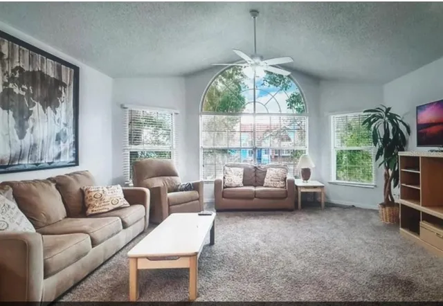 a living room with furniture and a large window