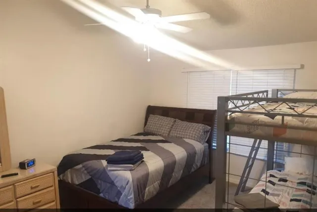 a bedroom with a bed and a window