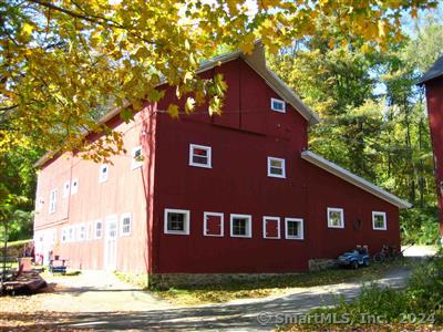 1206 A Bassett Road, Unit A Watertown, CT 06795 - Photo 1 of 1 a red brick house with trees in front of it