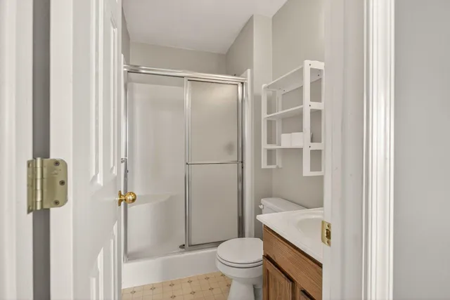 a bathroom with a shower and a toilet
