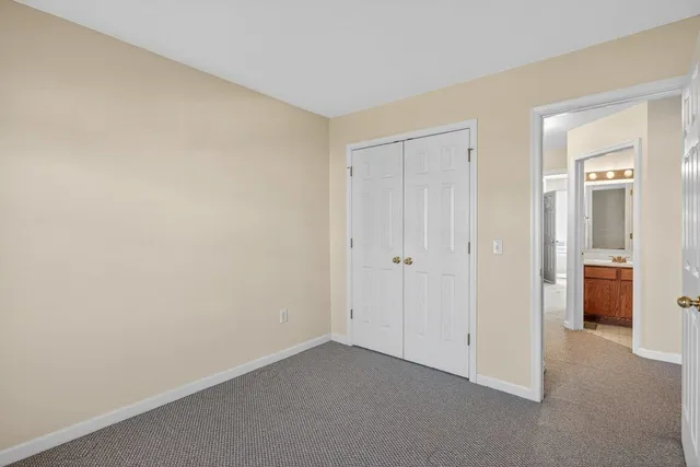 a view of an empty room and closet