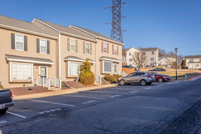 a view of a cars park in front of a building