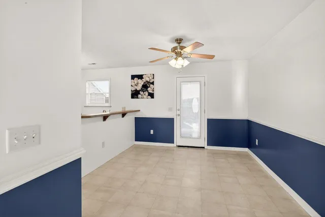 a view of a kitchen with wooden cabinet and a ceiling fan