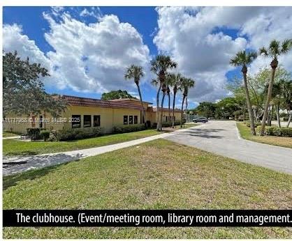 812 Southwest 9th St Circle, Unit 101 Boca Raton, FL 33486 - Photo 16 of 17 a front view of a house with a yard