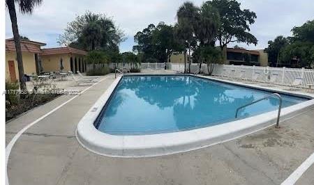 812 Southwest 9th St Circle, Unit 101 Boca Raton, FL 33486 - Photo 17 of 17 a view of a swimming pool with a patio