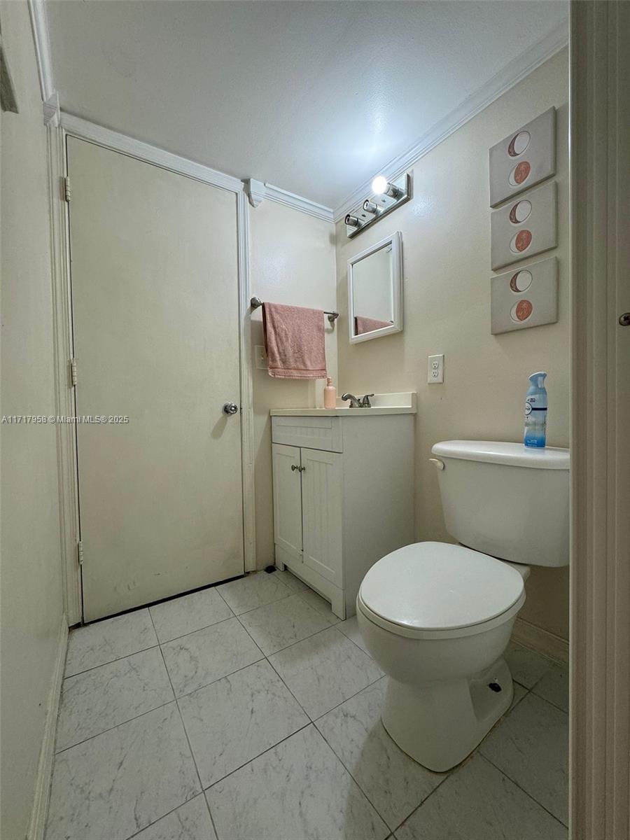 812 Southwest 9th St Circle, Unit 101 Boca Raton, FL 33486 - Photo 4 of 17 a bathroom with a toilet sink and shower