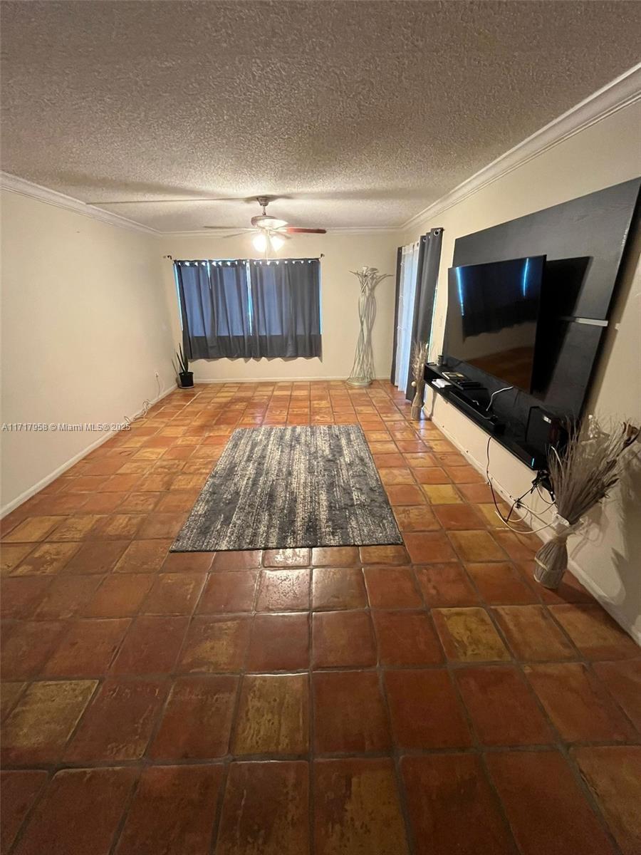 812 Southwest 9th St Circle, Unit 101 Boca Raton, FL 33486 - Photo 7 of 17 a bedroom with a bed and a flat screen tv