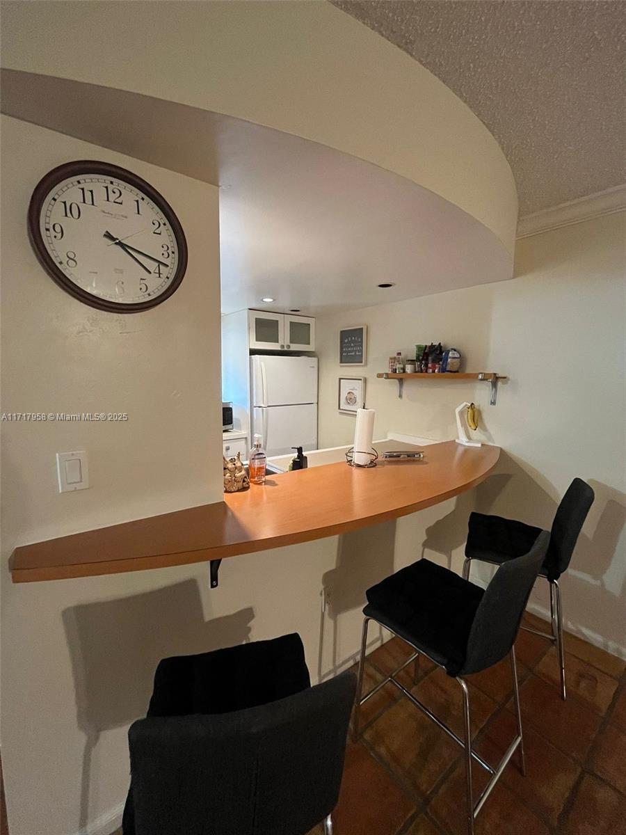 812 Southwest 9th St Circle, Unit 101 Boca Raton, FL 33486 - Photo 9 of 17 a room with a table chairs and a painting on the wall