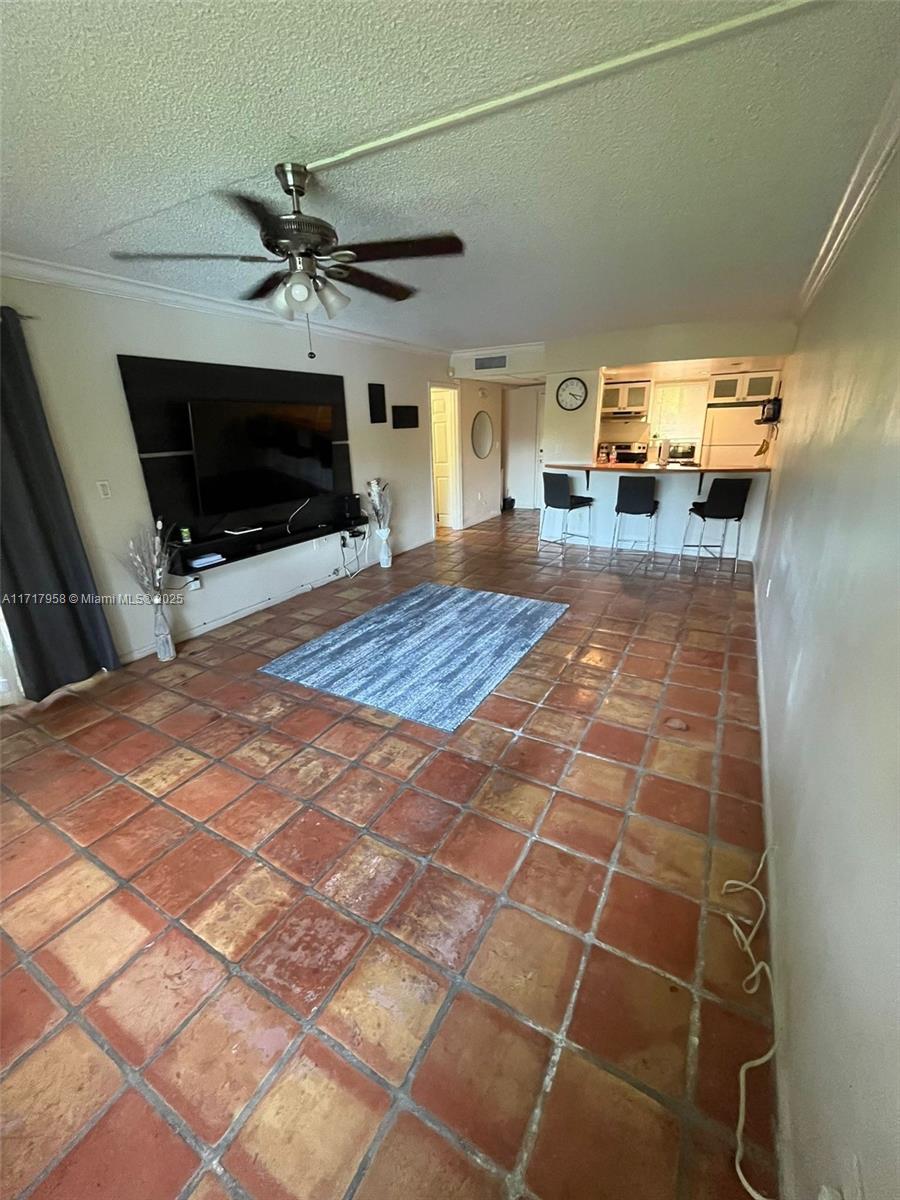 812 Southwest 9th St Circle, Unit 101 Boca Raton, FL 33486 - Photo 10 of 17 a bedroom with a bed and a flat screen tv