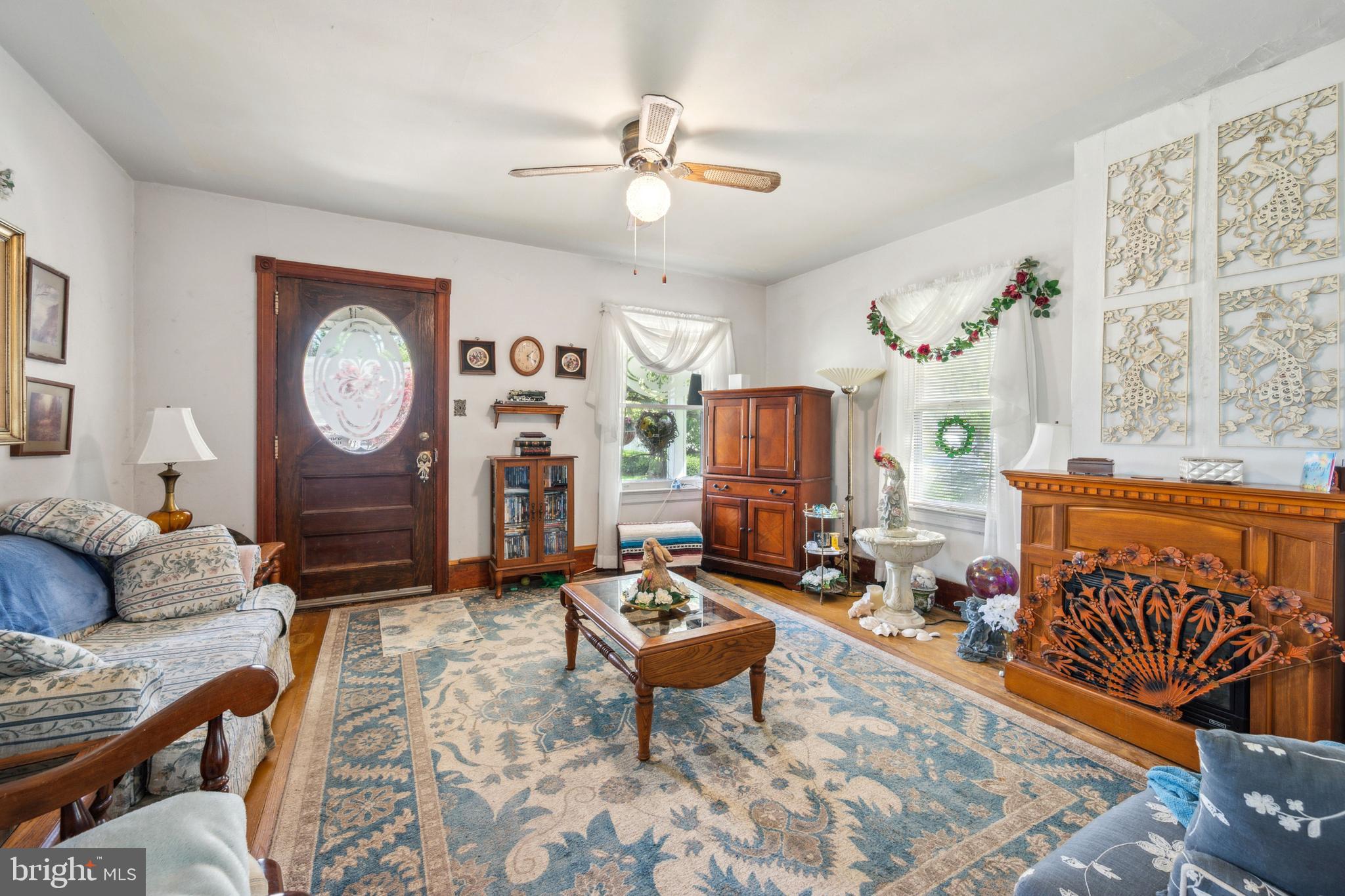 21 Devlin Avenue Burlington, NJ 08016 - Photo 4 of 20 a living room with furniture a clock on wall and a table