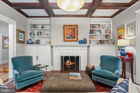 a dining room with furniture a chandelier and wooden floor