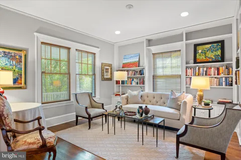 a kitchen with kitchen island granite countertop a sink cabinets and wooden floor
