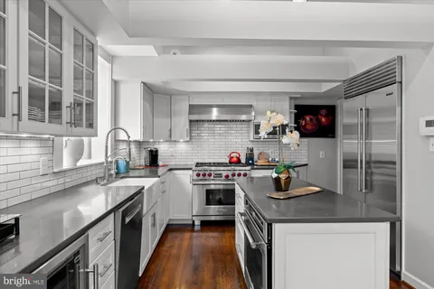 a bathroom with double vanity sink a mirror and a window