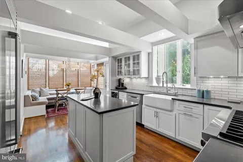 a bathroom with a sink a toilet a mirror and tub