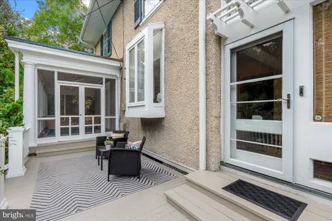 a view of a workspace with furniture and wooden floor