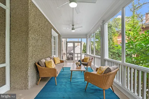a kitchen with white cabinets and refrigerator