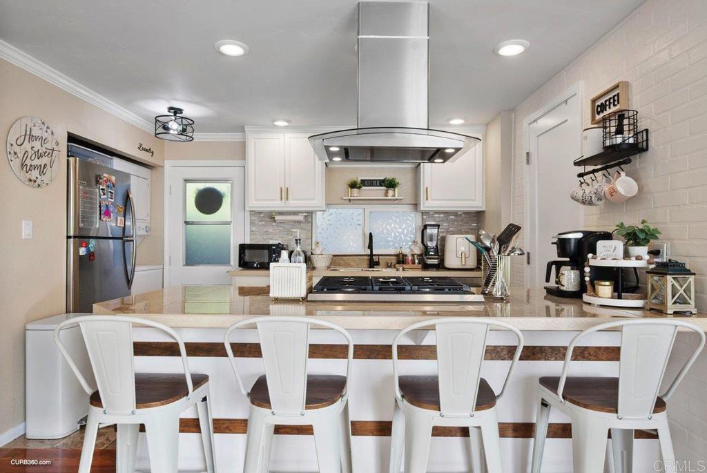 a kitchen with stainless steel appliances kitchen island granite countertop a table and chairs
