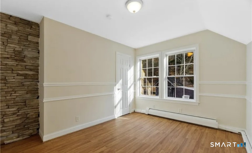 204 Main Street Sterling, CT 06377 - Photo 2 of 6 an empty room with wooden floor and windows