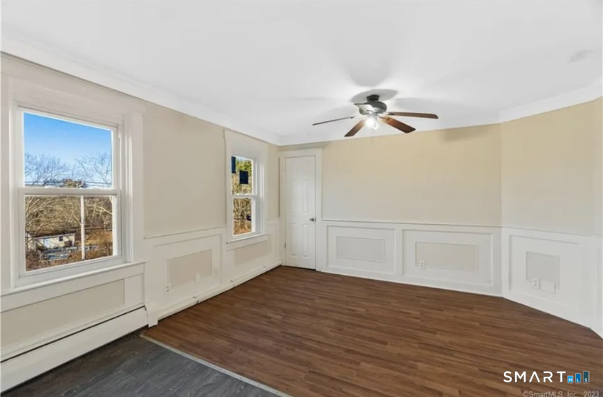 204 Main Street Sterling, CT 06377 - Photo 5 of 6 a view of an empty room with a window and wooden floor
