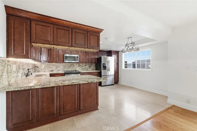 a kitchen with granite countertop a sink and cabinets