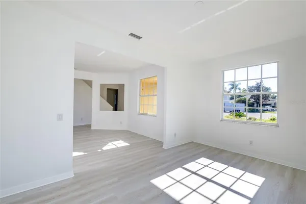 an empty room with windows and closet