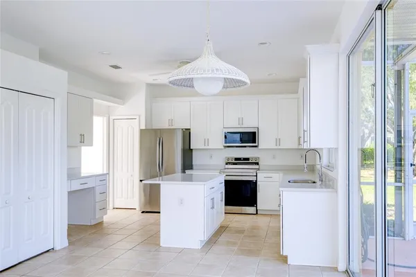 a kitchen with stainless steel appliances a refrigerator stove and sink