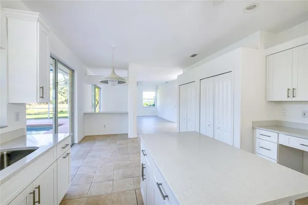 a large white kitchen with a sink and dishwasher refrigerator stove