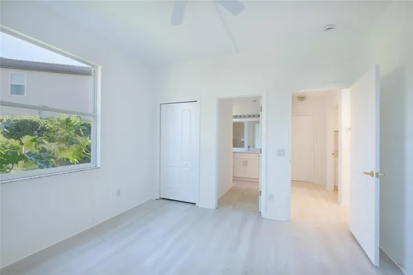 an empty room with windows and closet