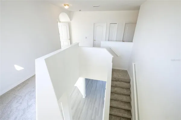 a view of a hallway with staircase