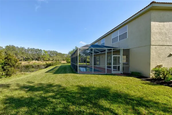 a view of a house with a yard and sitting area