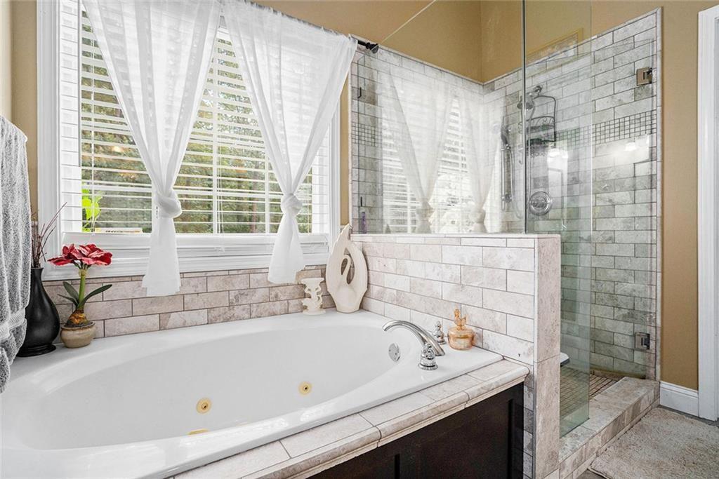 3792 Falls Trail Winston, GA 30187 - Photo 16 of 33 a bathroom with a bathtub and a sink
