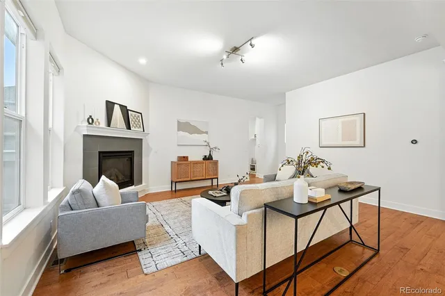 a living room with furniture a fireplace and a flat screen tv