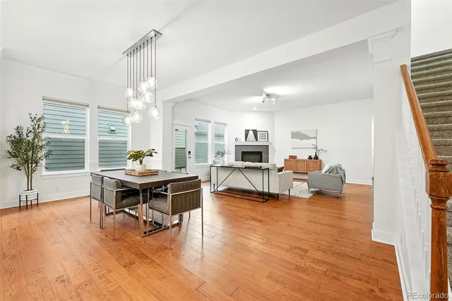 a living room with furniture and a dining table with kitchen view