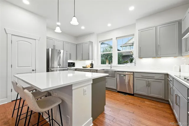 a kitchen with stainless steel appliances kitchen island granite countertop a sink and microwave