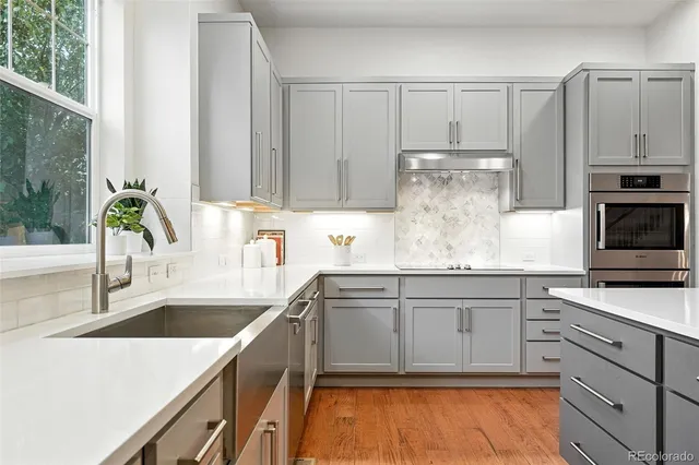 a kitchen with stainless steel appliances granite countertop a sink and cabinets
