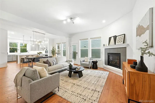 a living room with furniture large window and a fireplace