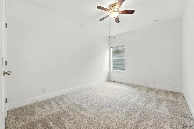 a view of room with a ceiling fan and window
