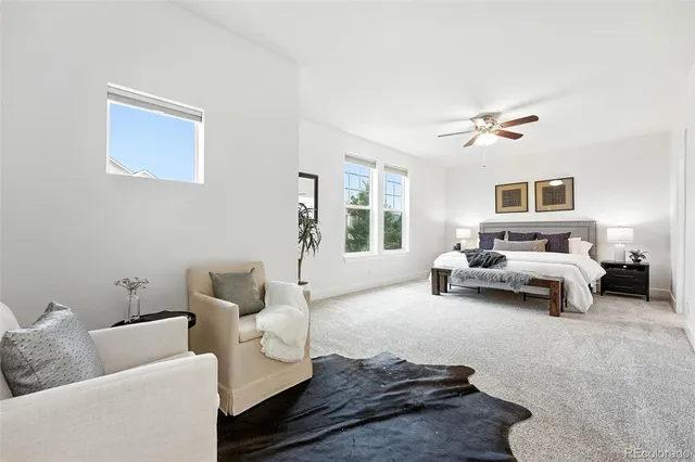 a spacious bedroom with a bed and a couch