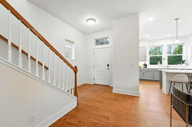 a view of entryway and hall with wooden floor