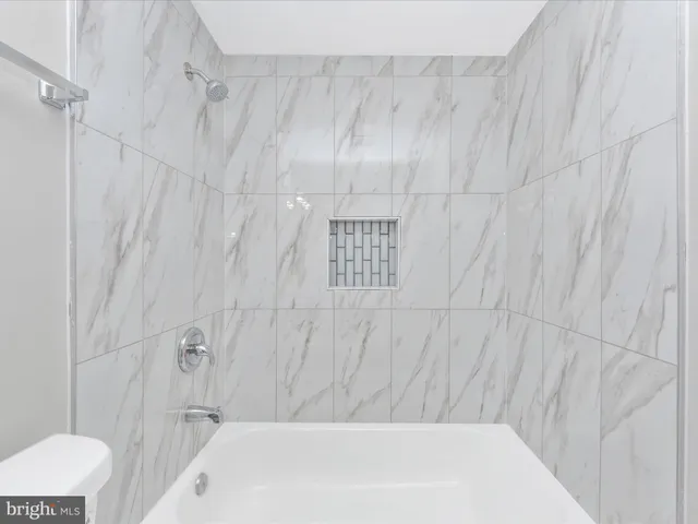 a bathroom with a white bathtub