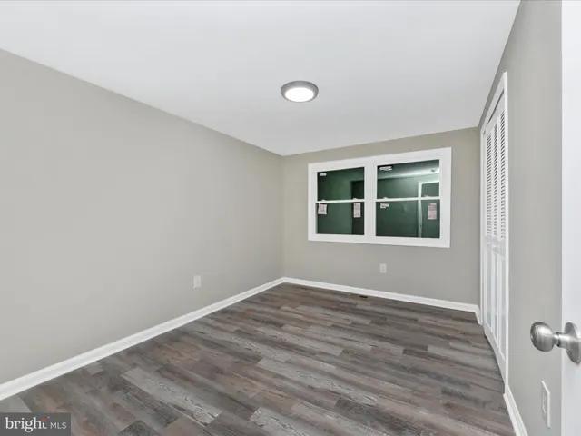 wooden floor and window in an empty room