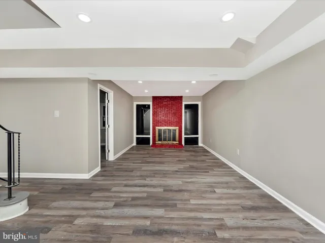 a big room with wooden floor and windows