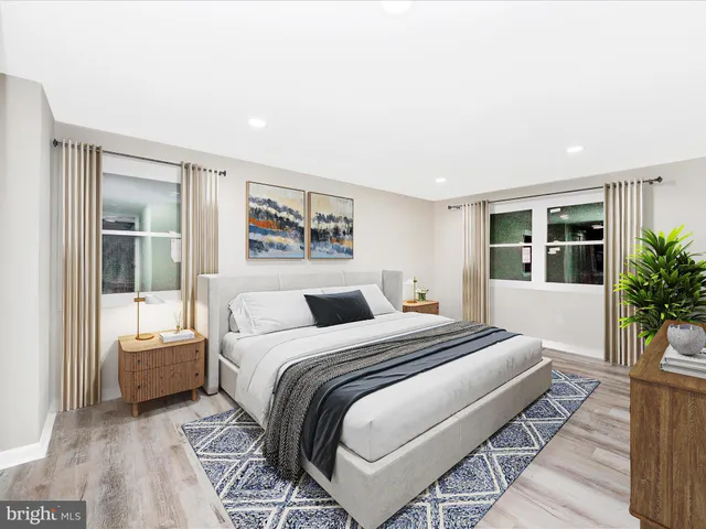 a bedroom with a large bed and a potted plant