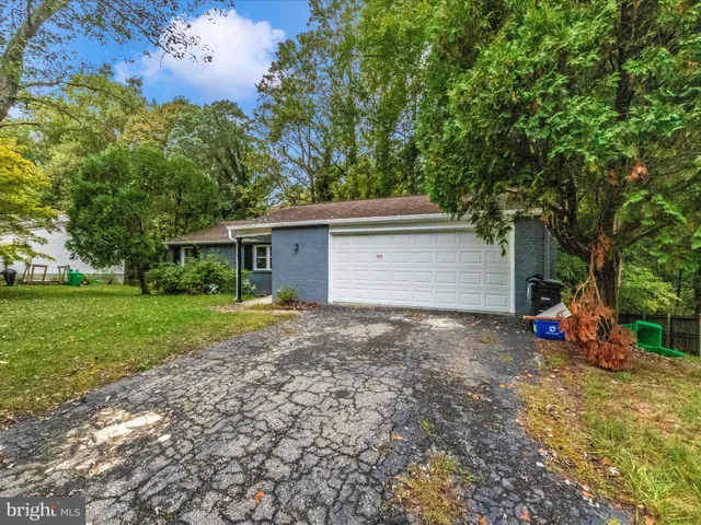 a view of a house with backyard and a tree