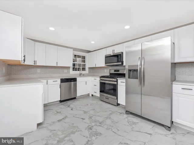 a kitchen with a refrigerator stove and microwave