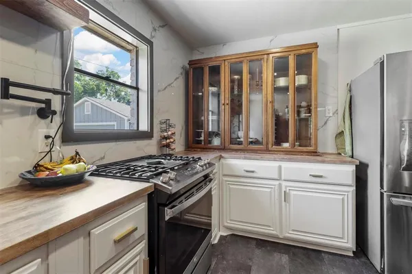 a kitchen with stainless steel appliances a stove and a sink