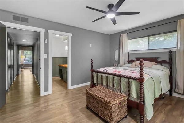 a bedroom with a bed and a chandelier