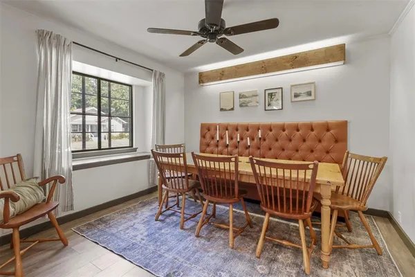 a view of a dining room with furniture window and wooden floor